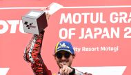 Ducati Lenovo Team rider Francesco Bagnaia of Italy raises his victory trophy on the MotoGP class race podium of MotoGP Japanese Grand Prix on October 6, 2024. (Photo by Toshifumi Kitamura / AFP)