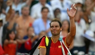 (FILES) Spain's Rafael Nadal waves as he leaves after he and Spain's Carlos Alcaraz beat Netherlands' Tallon Griekspoor and Netherlands' Wesley Koolhof in their men's doubles second round tennis match on Court Suzanne-Lenglen at the Roland-Garros Stadium during the Paris 2024 Olympic Games, in Paris on July 30, 2024. (Photo by MARTIN BERNETTI / AFP)
