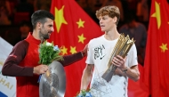 Italy's Jannik Sinner (R) is greeted by Serbia's Novak Djokovic after Sinner won their men's singles final match at the Shanghai Masters tennis tournament on October 13, 2024. (Photo by Hector Retamal / AFP)