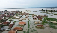 This aerial view shows houses submerged under water in Adankolo in Kogi State on October 12, 2024. (Photo by Haruna Yahaya / AFP)