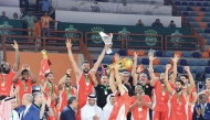 Al Arabi players and officials celebrate after winning the Arab Clubs Men’s Basketball title.