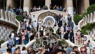 Tourists visit Park Guell in Barcelona on October 11, 2024. (Photo by Josep Lago / AFP)