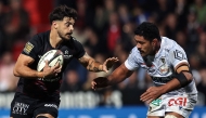 Toulouse's French fly-half Romain Ntamack (L) runs to evade Clermont's Samoan number eight Fritz Lee during the French Top14 rugby union match between Stade Toulousain Rugby (Toulouse) and ASM Clermont Auvergne at the Ernest-Wallon stadium in Toulouse, south-western France, on October 12, 2024. (Photo by Valentine CHAPUIS / AFP)
