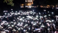 Fans light cellphones as they pay tribute to the late British singer Liam Payne at the Revolucion monument in Mexico City on October 17, 2024. Photo by Yuri CORTEZ / AFP