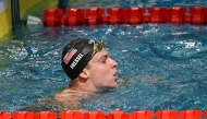 France's Leon Marchand reacts after competing in the men 100m medley event during the World Aquatics Swimming World Cup 2024 - Stop 1 at the Oriental Sports Centre Natatorium in Shanghai, on October 18, 2024. (Photo by Hector RETAMAL / AFP)