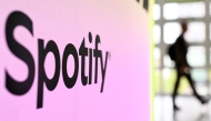 A person walks past a banner with an Spotify logo at the Frankfurt book fair on October 17, 2024. Photo by Kirill KUDRYAVTSEV / AFP
