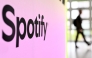 A person walks past a banner with an Spotify logo at the Frankfurt book fair on October 17, 2024. Photo by Kirill KUDRYAVTSEV / AFP