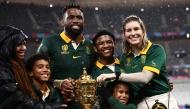 (Files) South Africa's flanker and captain Siya Kolisi (3rd L) and his wife Rachel Kolisi (R) pose for a photo with their family after South Africa won the France 2023 Rugby World Cup Final match  on October 28, 2023. (Photo by Anne-Christine Poujoulat / AFP)