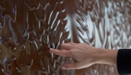 A woman puts her finger in chocolate waterfall at the entrance to the E. Wedel Chocolate Factory museum in Warsaw, Poland on October 10, 2024. Photo by Wojtek RADWANSKI / AFP