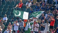 A Pakistni fan waves the national flag during the third day of the third and final Test cricket match between Pakistan and England at the Rawalpindi Cricket Stadium in Rawalpindi on October 26, 2024. (Photo by Aamir QURESHI / AFP)
