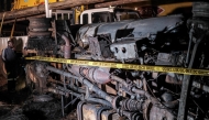 The charred wreckage of a fuel truck is marked as a crime scene following an explosion in Kigogwa, on October 22, 2024. Photo by Badru Katumba / AFP