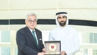 QOC Director of Sports Sector Sheikh Khalifa bin Khalid Al Thani presents a souvenir to World Taekwondo President Dr. Chungwon Choue during the meeting.    