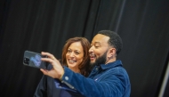 Democratic presidential nominee, US Vice President Kamala Harris takes a selfie with musician John Legend before she speaks during a campaign rally at The Alan Horwitz 