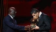 Manchester City's Spanish midfielder Rodri kisses the trophy as he receives the Ballon d'Or award during the 2024 Ballon d'Or France Football award ceremony at the Theatre du Chatelet in Paris on October 28, 2024. (Photo by FRANCK FIFE / AFP)
