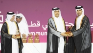 Prime Minister and Minister of Foreign Affairs H E Sheikh Mohammed bin Abdulrahman bin Jassim Al Thani awarding students at the Community College of Qatar graduation.