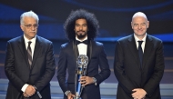 Qatar's forward Akram Afif (C) poses with FIFA president Gianni Infantino (R) and Sheikh Salman bin Ibrahim al-Khalifa (L), president of the Asian Football Confederation (AFC), after receiving the AFC Player of the Year award during the AFC Annual Awards 2023 ceremony in Seoul on October 29, 2024. (Photo by JUNG YEON-JE / AFP)