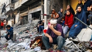 An injured man reacts while sitting on the rubble of a building hit by an Israeli strike in Beit Lahia, in the northern Gaza Strip, on October 29, 2024. Photo by AFP