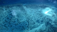 This aerial photo taken on April 5, 2024, shows a coral atoll near Lizard Island on the Great Barrier Reef, located 270 kilometres (167 miles) north of the city of Cairns. (Photo by DAVID GRAY / AFP) 