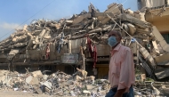 A man walks past a destroyed building in the aftermath of Israeli strikes in the neighbourhood of Haret Hreik in Beirut's southern suburbs on November 1, 2024. Photo by AFP.