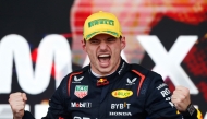 Red Bull Racing's Dutch driver Max Verstappen celebrates at the podium of the Formula One Sao Paulo Grand Prix, at the Jose Carlos Pace racetrack, aka Interlagos, in Sao Paulo, Brazil, on November 3, 2024. (Photo by Miguel Schincariol / AFP)