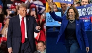 This combination of pictures created on November 02, 2024 shows Former US President and Republican presidential candidate Donald Trump (L) as he arrives on stage to speak during a campaign rally at the Sports and Expo Center at Macomb Community College in Warren, Michigan, November 1, 2024, and US Vice President and Democratic presidential candidate Kamala Harris (R) walks on stage as she arrives for a campaign rally at the Craig Ranch Amphitheater in Las Vegas, Nevada, on October 31, 2024.. (Photo by Roberto Schmidt and David Becker / AFP)