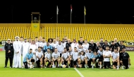 Al Sadd players and officials pose for a photograph at Zabeel Stadium in Zabeel, Dubai, on the eve of the match against Al Wasl.