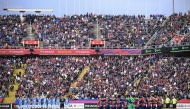 Both teams' players observe a minute of silence for the flood victims in the Valencia region before the the Spanish league football match between FC Barcelona and RCD Espanyol at the Estadi Olimpic Lluis Companys in Barcelona, on November 3, 2024. (Photo by Josep LAGO / AFP)
