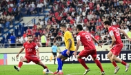 Al Gharafa's Joselu (second left) is challenged by Persepolis players.