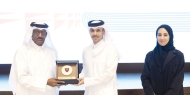 QOC Secretary General Jassim bin Rashid Al Buenain presents a memento to Asian Athletics Association President Dahlan Al Hamad.