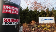 Pro-union stickers are pictured on a pole outside the Boeing Renton Production Facility one day before striking union members will vote on a new contract offer in Renton, Washington on November 3, 2024. (Photo by Jason Redmond / AFP)