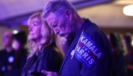 A supporter of Democratic presidential nominee, Vice President Kamala Harris checks his phone at an Arizona Democratic election night watch party on November 5, 2024 in Phoenix, Arizona. Mario Tama/Getty Images/AFP 