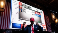 A supporter of US Presidential candidate Donald Trump poses for a picture at a restaurant as he follows the US election results in Mexico City on November 5, 2024. (Photo by Yuri Cortez / AFP)