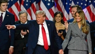 Former US President and Republican presidential candidate Donald Trump gestures at supporters after speaking during an election night event on November 6, 2024. (Photo by Jim Watson / AFP)