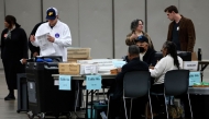 Workers process absentee ballots for the 2024 General Election at Huntington Place on November 5, 2024 in Detroit, Michigan. (Photo by JEFF KOWALSKY / AFP)
