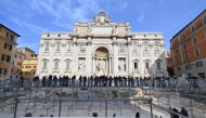 People walk on the temporary suspended walkway opening today at Trevi Fountain allowing visitors to see the fountain closer during renovation works, in Rome, on November 9, 2024. (Photo by Andreas Solaro / AFP)