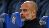 Manchester City's Spanish manager Pep Guardiola takes his seat for the English Premier League football match between Brighton and Hove Albion and Manchester City at the American Express Community Stadium in Brighton, southern England on November 9, 2024. (Photo by Glyn KIRK / AFP) 