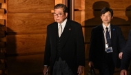 Japan's Prime Minister Shigeru Ishiba (L) leaves the prime minister's official residence to attend a ceremony with the emperor at the Imperial Palace in Tokyo on November 11, 2024. (Photo by Toshifumi Kitamura / AFP)