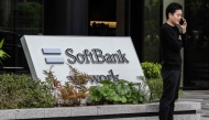 (FILES) This file photo taken on May 2, 2024 shows a man talking on his phone outside the headquarters for Japanese company SoftBank Group in Tokyo. (Photo by Yuichi YAMAZAKI / AFP)
