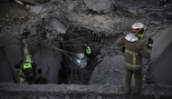 Rescue teams looks for survivors at the site of an Israeli airstrike that targeted a house where displaced people lived in the village of Baalshmay in the Lebanese mountains, east of Beirut, on November 12, 2024. (Photo by Fadel Itani / AFP)