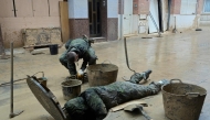 Soldiers evacuate mud from a sewer in Paiporta, south of Valencia, eastern Spain, on November 13, 2024 in the aftermath of deadly flooding. (Photo by Jose Jordan / AFP)