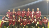 Qatar archers and officials pose for a photograph. 