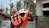 This handout photo taken on November 14, 2024, shows a rescuer carrying a young resident during a forced evacuation operation in Buguey town, Cagayan province, north of Manila. (Photo by Handout / Buguey Municipal Disaster Risk and Reduction Management Office via Cagayan Provincial Public Information Office / AFP) 