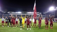 Qatar's players celebrate after winning the 2026 FIFA World Cup Asian qualification football match between Qatar and Uzbekistan at the Jassim bin Hamad Stadium in Doha on November 14, 2024. (Photo by Karim Jaafar / AFP)