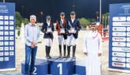 The podium winners of the Small Tour pose for a photo with  officials.