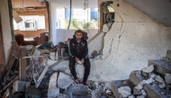 A man reacts as he sits in a heavily damaged building following an Israeli strike in Deir Al-Balah in the central Gaza Strip on November 15, 2024. (Photo by Eyad Baba / AFP)
