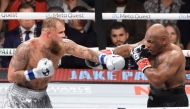 Jake Paul (L) and Mike Tyson throw punches during their heavyweight bout at AT&T Stadium on November 15, 2024 in Arlington, Texas. Christian Petersen/Getty Images/AFP 