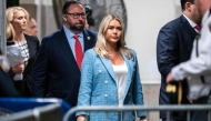 (Files) Trump campaign press secretary Karoline Leavitt (C) and Trump adviser Jason Miller (L) arrive at the criminal trial of former US President and Republican presidential candidate Donald Trump's criminal trial at Manhattan Criminal Court in New York City on May 29, 2024. (Photo by Doug Mills / POOL / AFP)