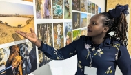 Kenyan climate scientist Joyce Kimutai points at a photograph during the United Nations Climate Change Conference (COP29) in Baku on November 15, 2024. (Photo by Nick Perry / AFP)