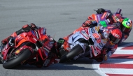 Ducati Italian rider Francesco Bagnaia rides ahead of Ducati Spanish rider Marc Marquez and Ducati Italian rider Franco Morbidelli during the Moto GP qualifying session for the Solidarity Grand Prix of Barcelona at the Circuit de Catalunya on November 16, 2024 in Montmelo on the outskirts of Barcelona. (Photo by Manaure Quintero / AFP)
