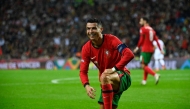 Portugal's forward Cristiano Ronaldo (L) reacts during the UEFA Nations League, League A, Group 1 football match between Portugal and Poland at the Dragao stadium in Porto, on November 15, 2024. (Photo by Miguel Riopa / AFP)